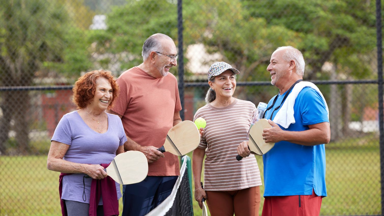 Seniors playing pickleball in park
