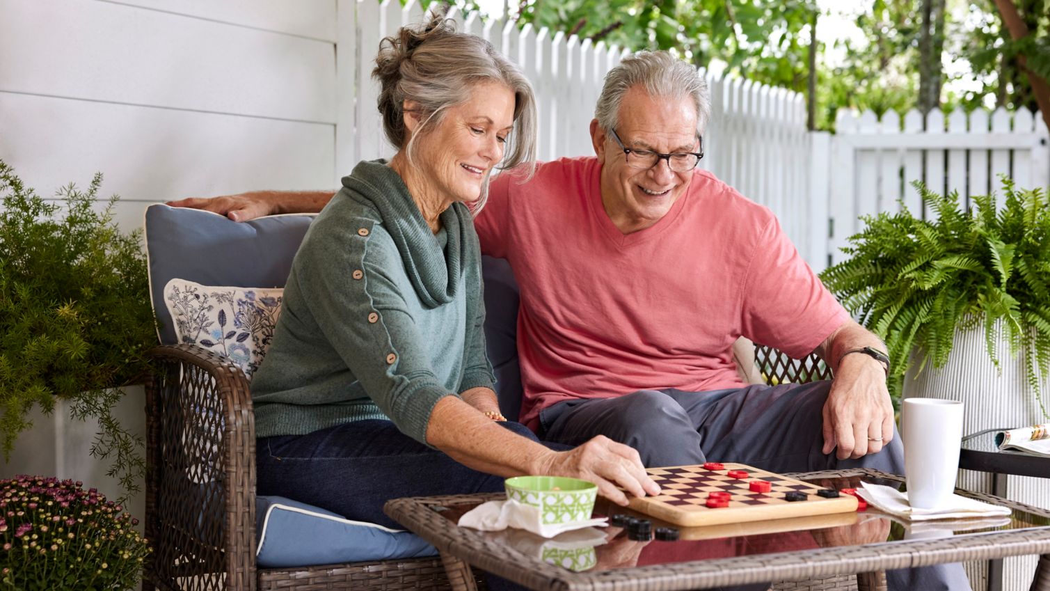 Two seniors playing checkers outdoors