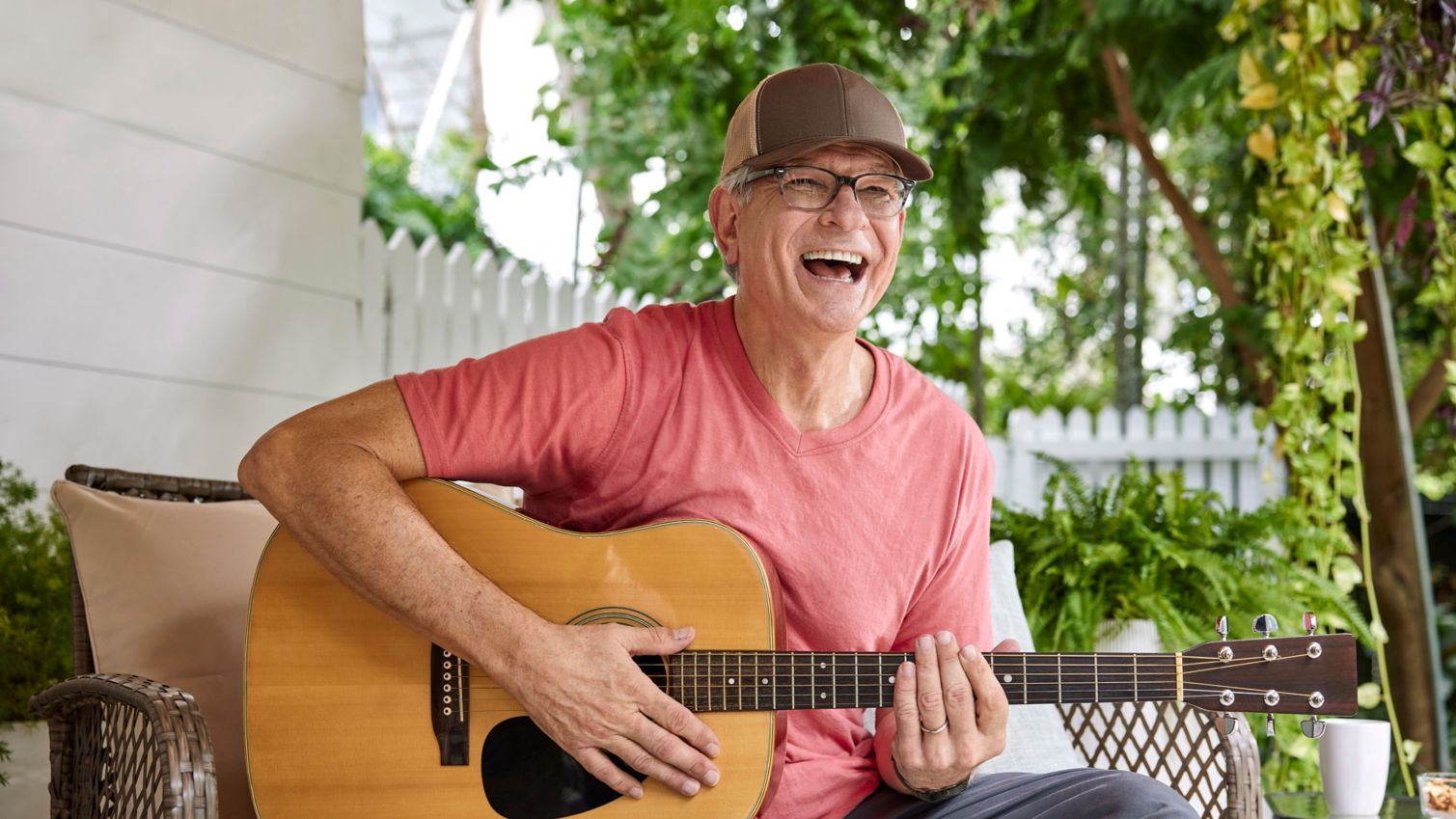 Senior relaxing and playing guitar.
