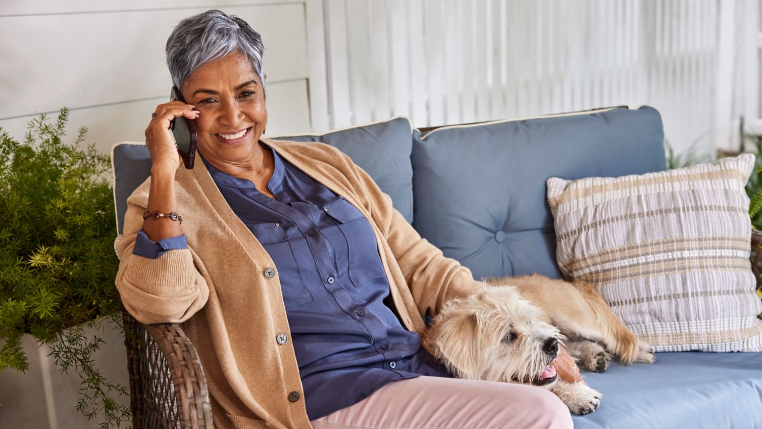 Senior relaxing and playing with pet dog