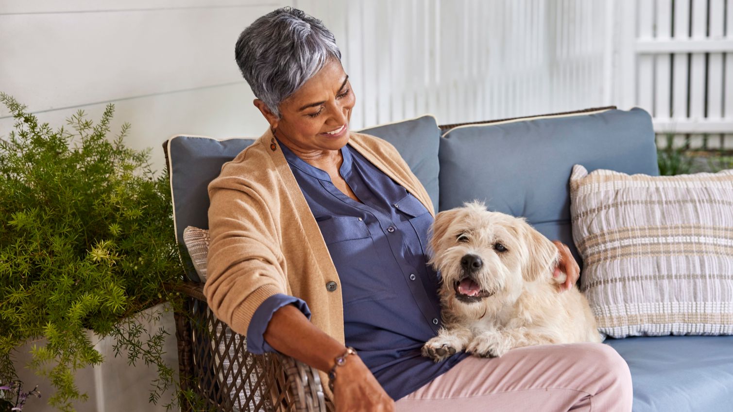 Senior relaxing and playing with pet dog