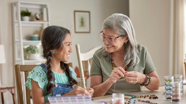 Senior adult doing crafts with a child