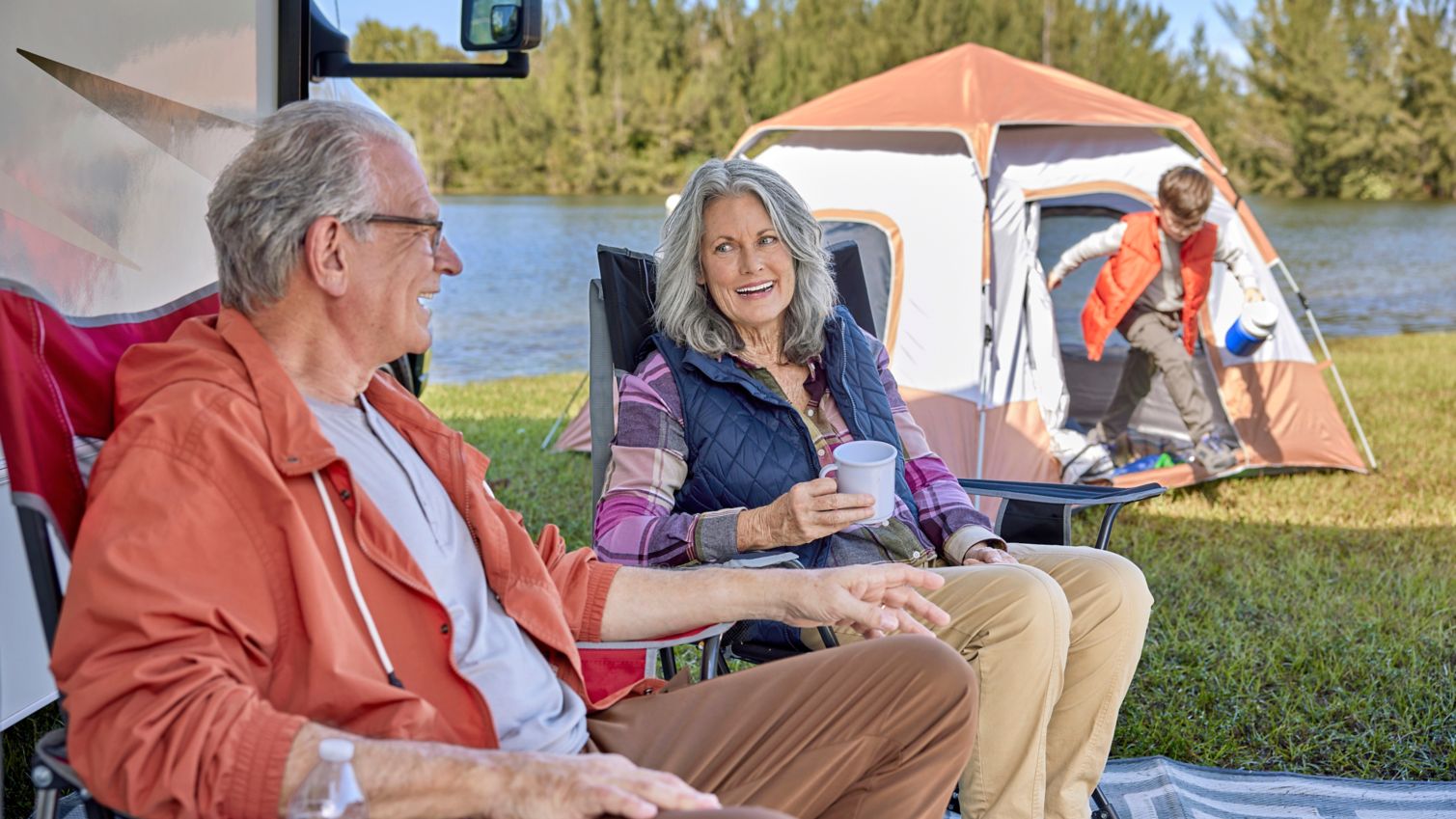 Seniors camping with Recreational Vehicle and child