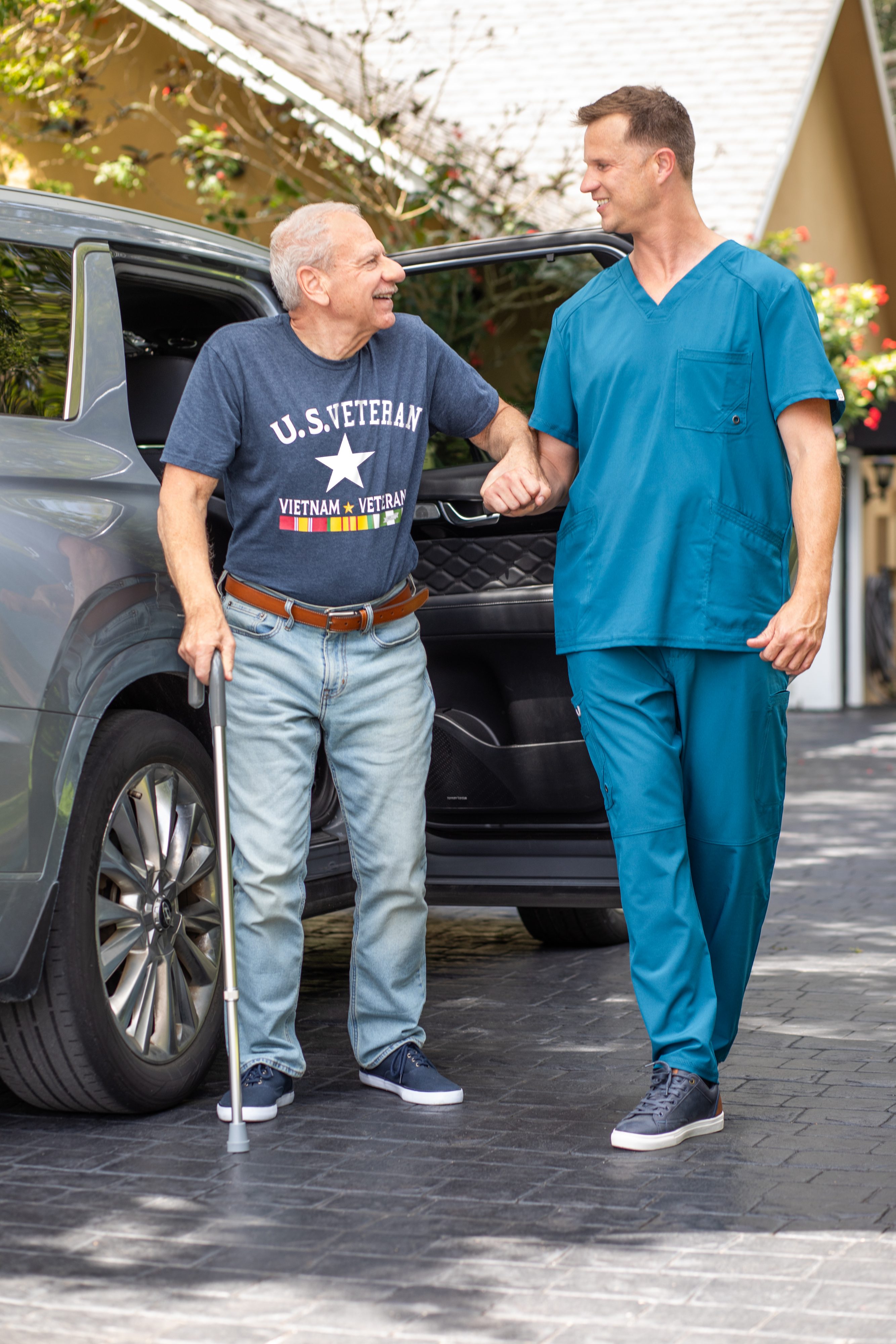 Rideshare driver assists senior man with cane out of a car