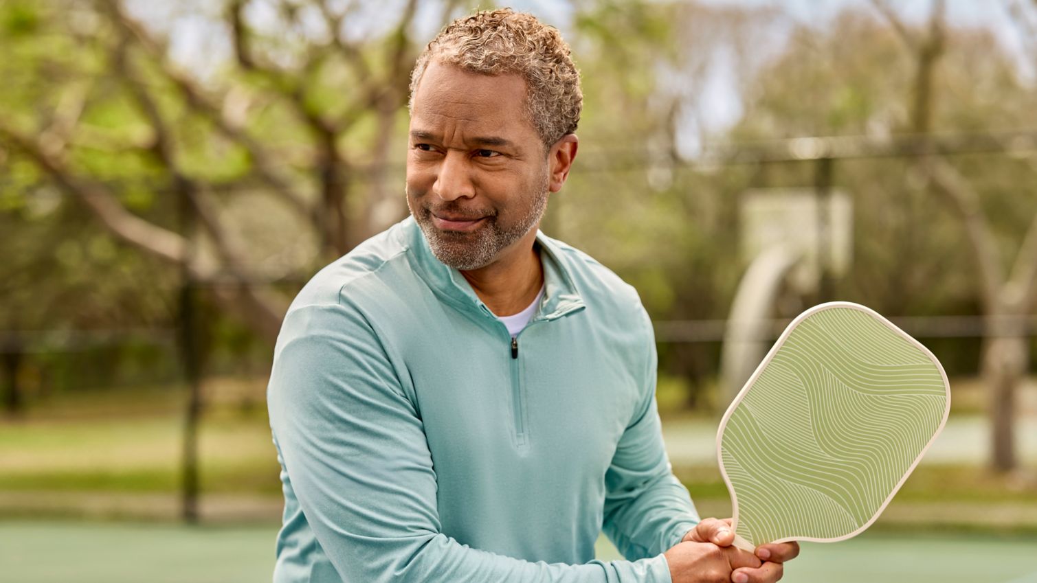a gentleman hits the pickleball court for a game