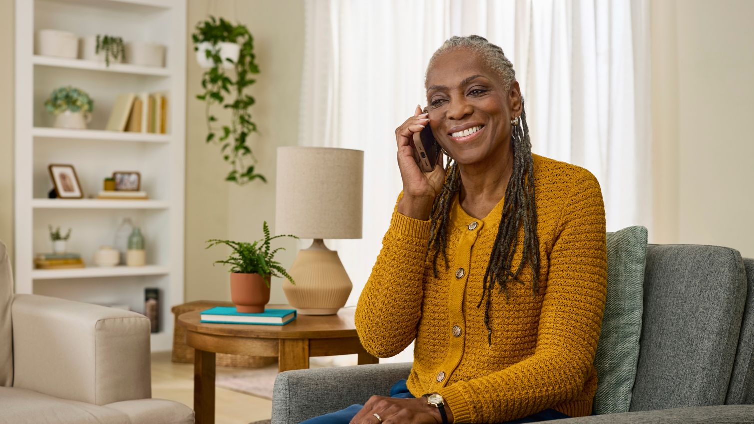 A couple meets with an agent on their porch. 