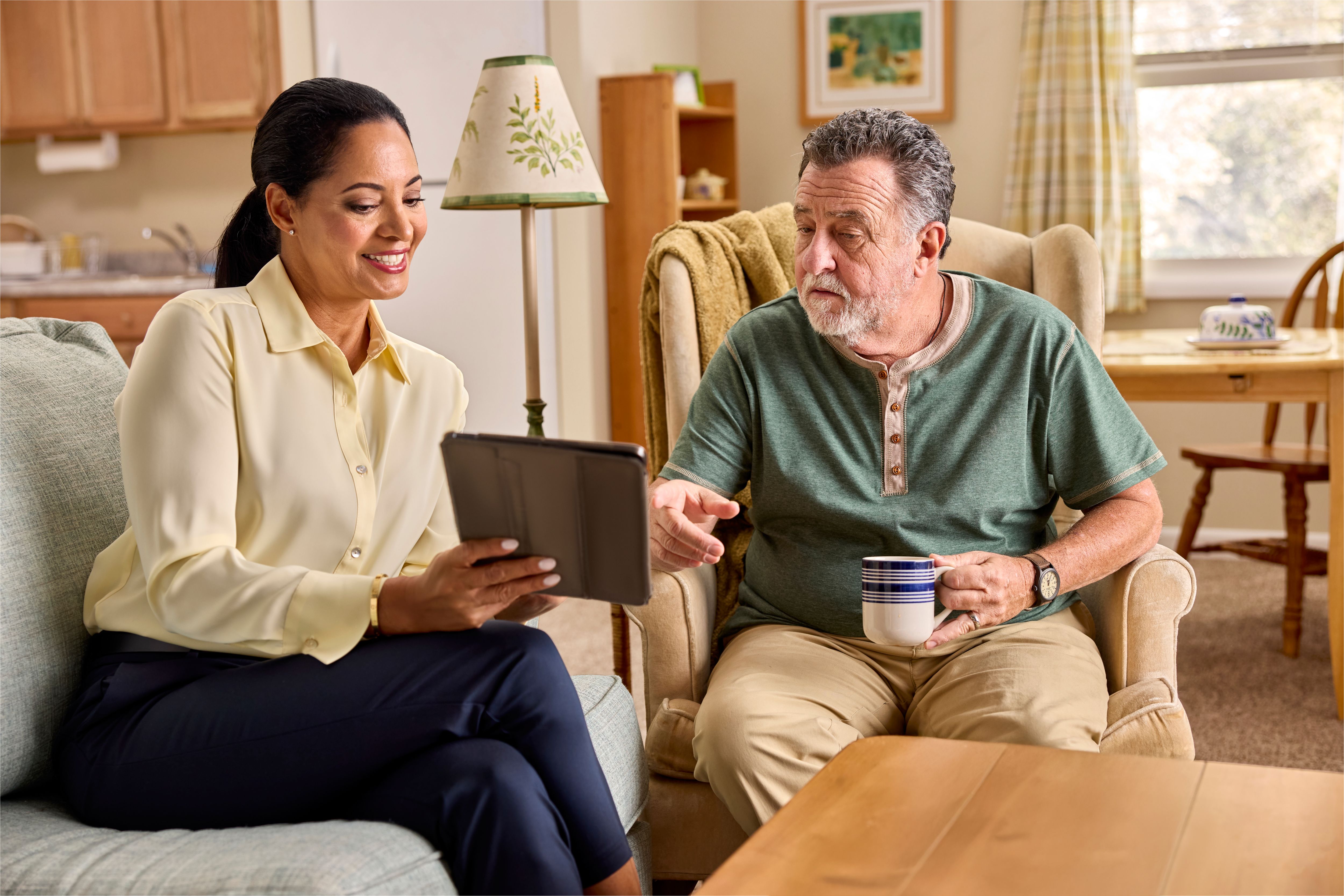A couple at home reviewing types of Medicare Advantage plans on their tablet  