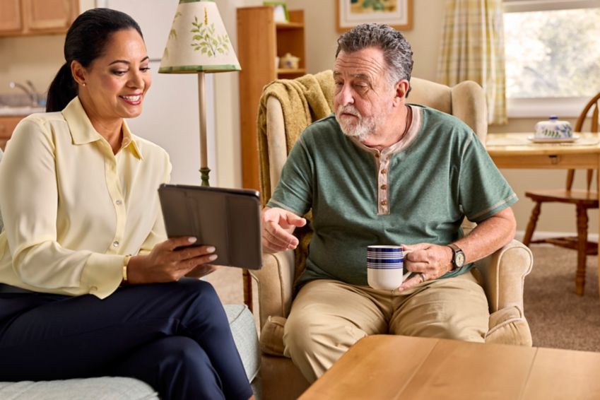 A couple at home reviewing types of Medicare Advantage plans on their tablet  