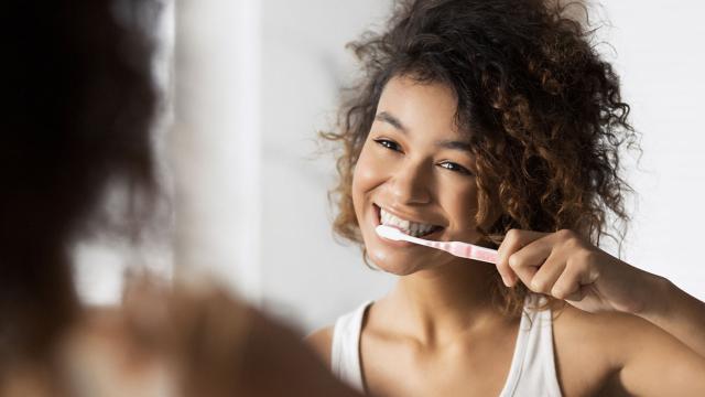 Teenager brushing her teeth.