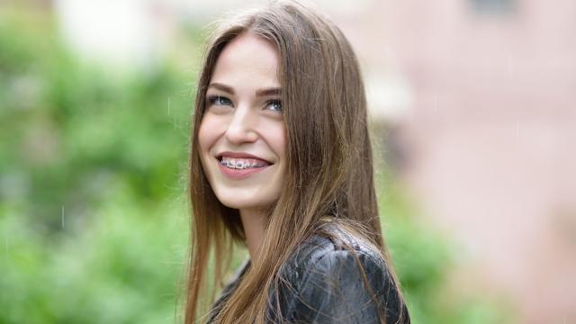 Teenage girl showing off her braces.