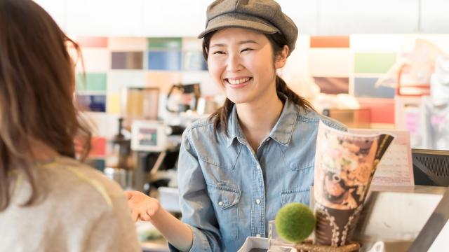 Woman smiling at store clerk.