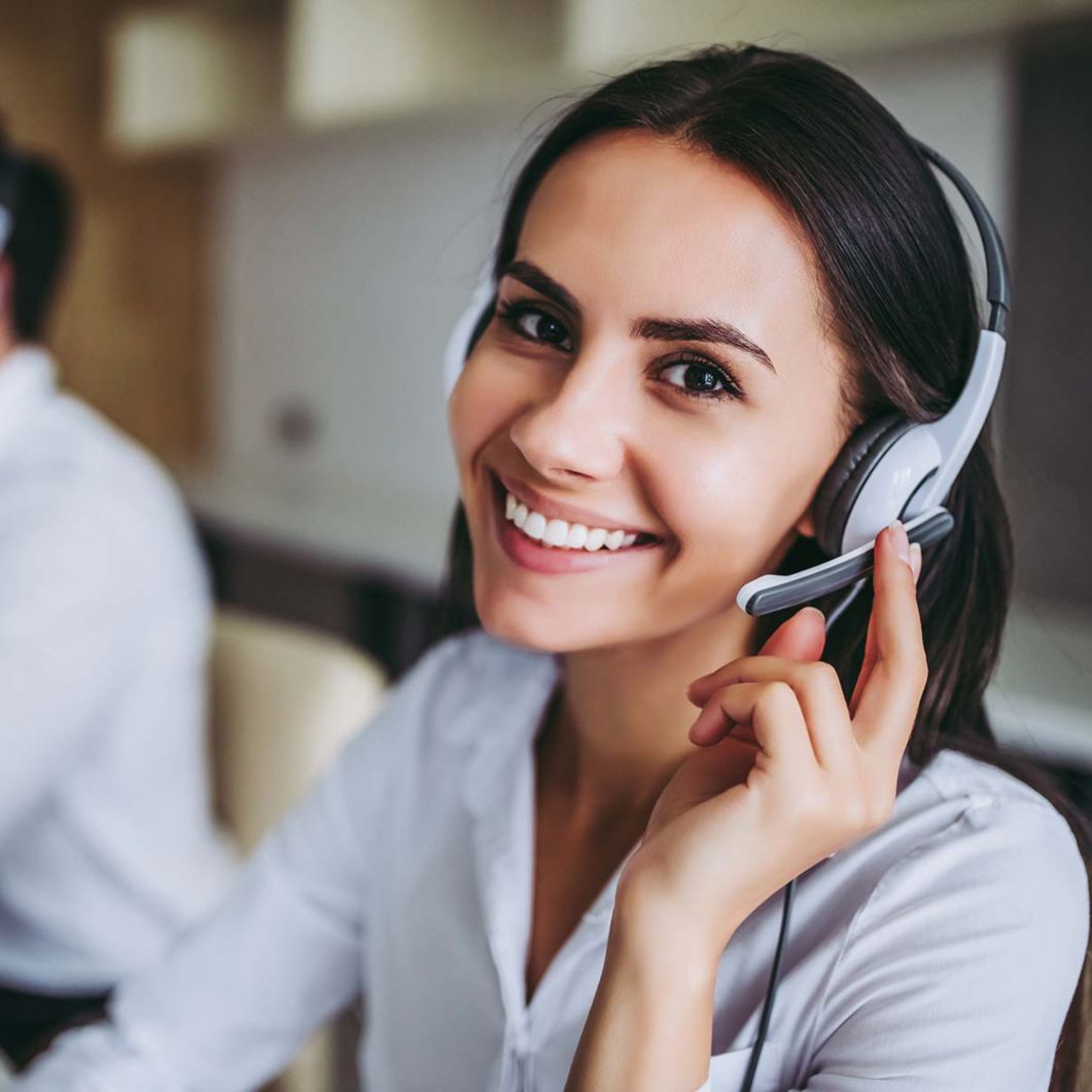 Woman using a headset to talk on the phone.