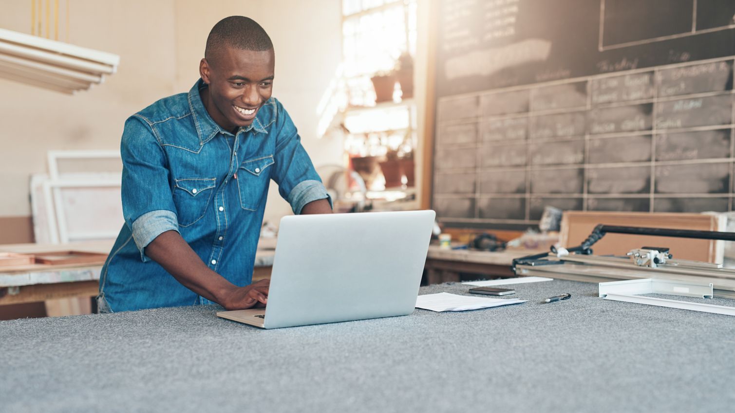 Young man in a workshop using Humana employer resources online