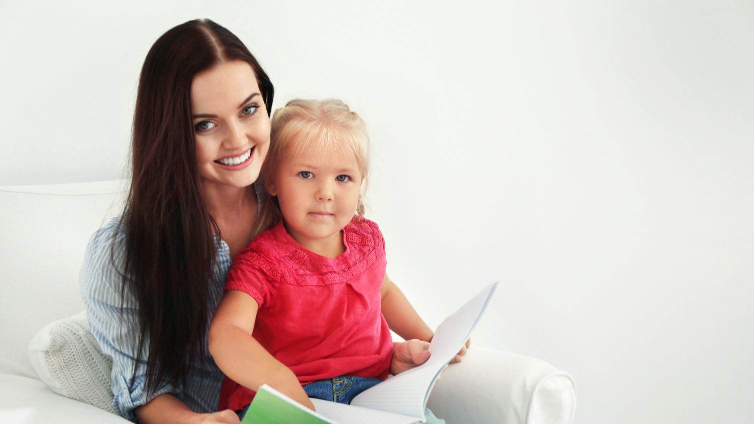 Adult and child reading a book