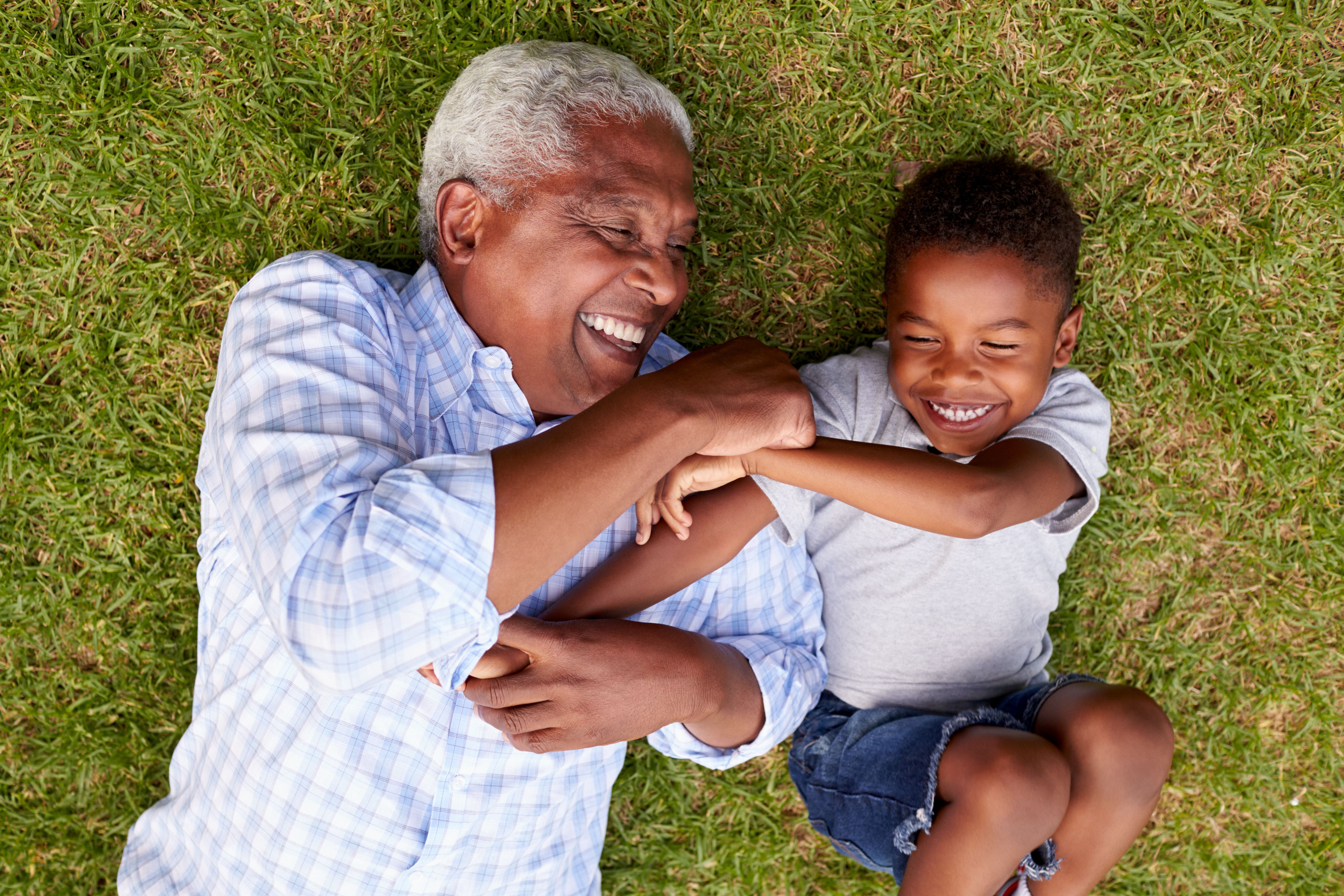 Senior man playing with young child