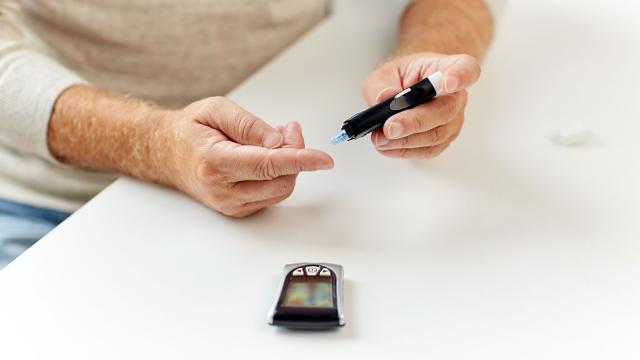 A man using a finger stick to check his blood sugar level