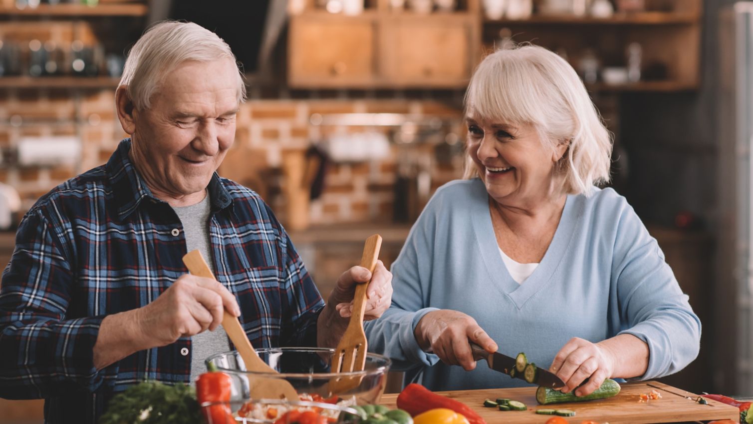 A retired couple preparing a healthy meal