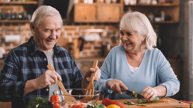 A retired couple prepares a healthy dinner