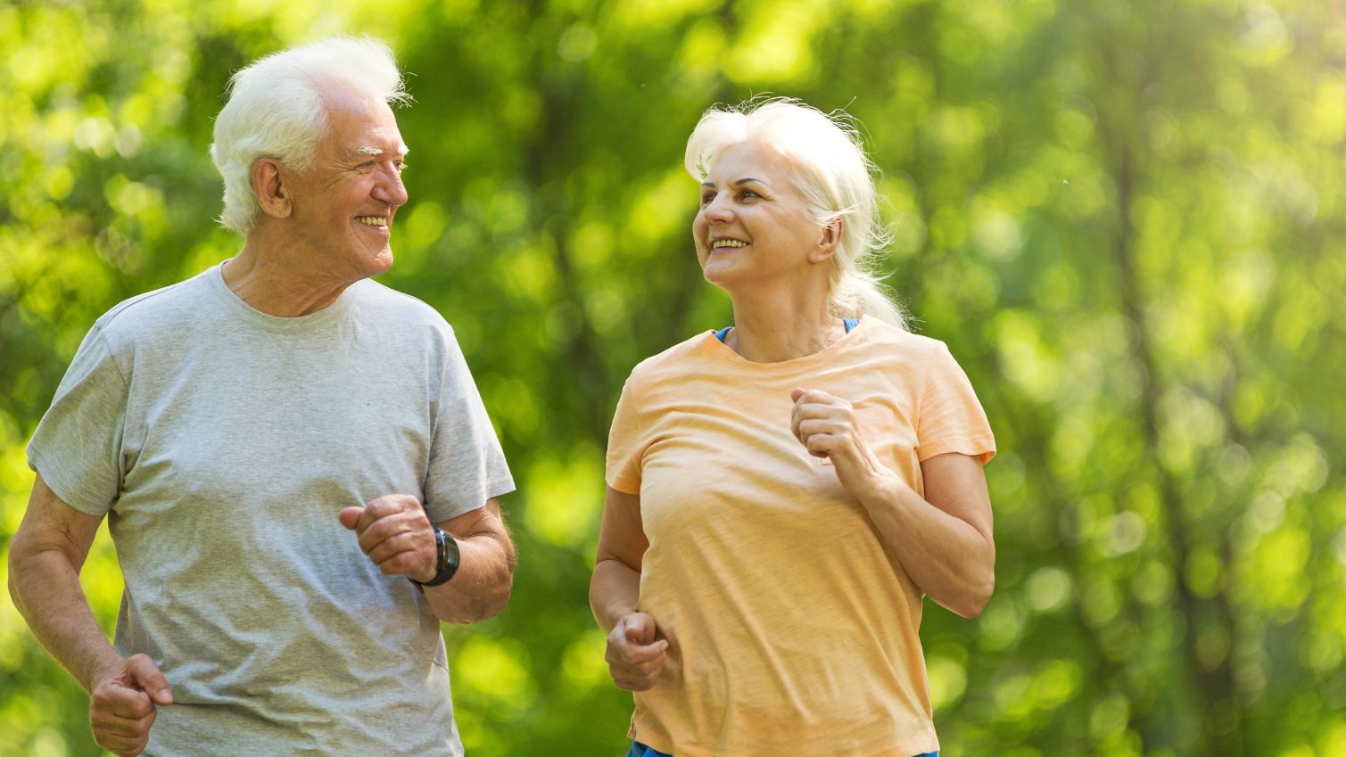 Retired couple taking an outdoor jog together.
