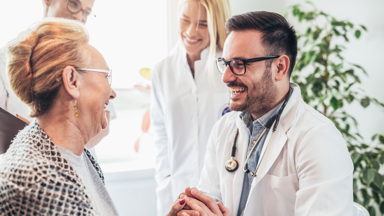 medical professional hold patient hands