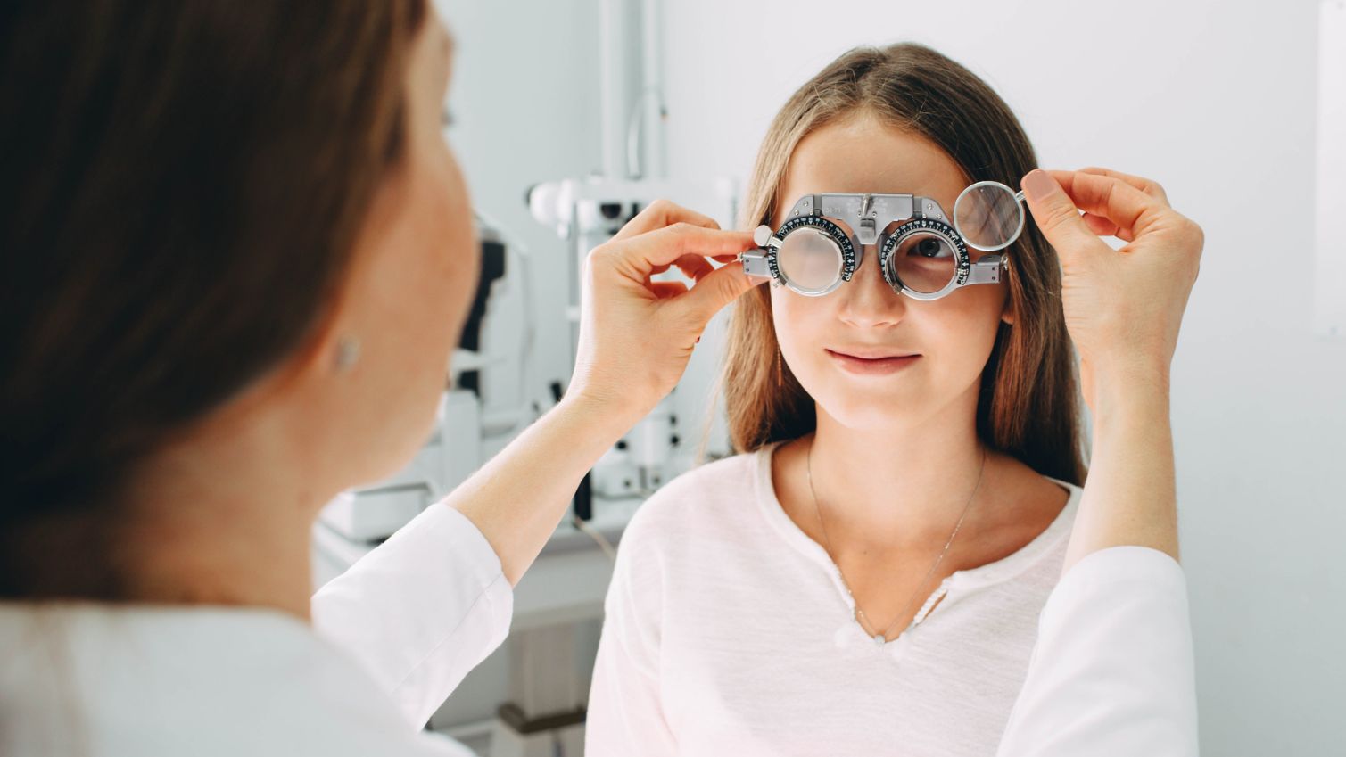 Child getting vision exam from vision professional