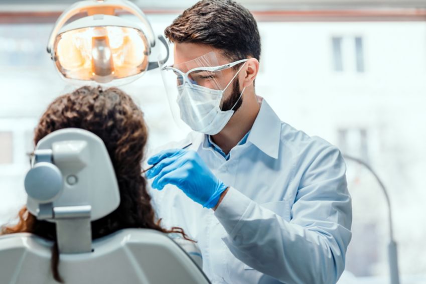Senior woman having a dental exam with dentist.