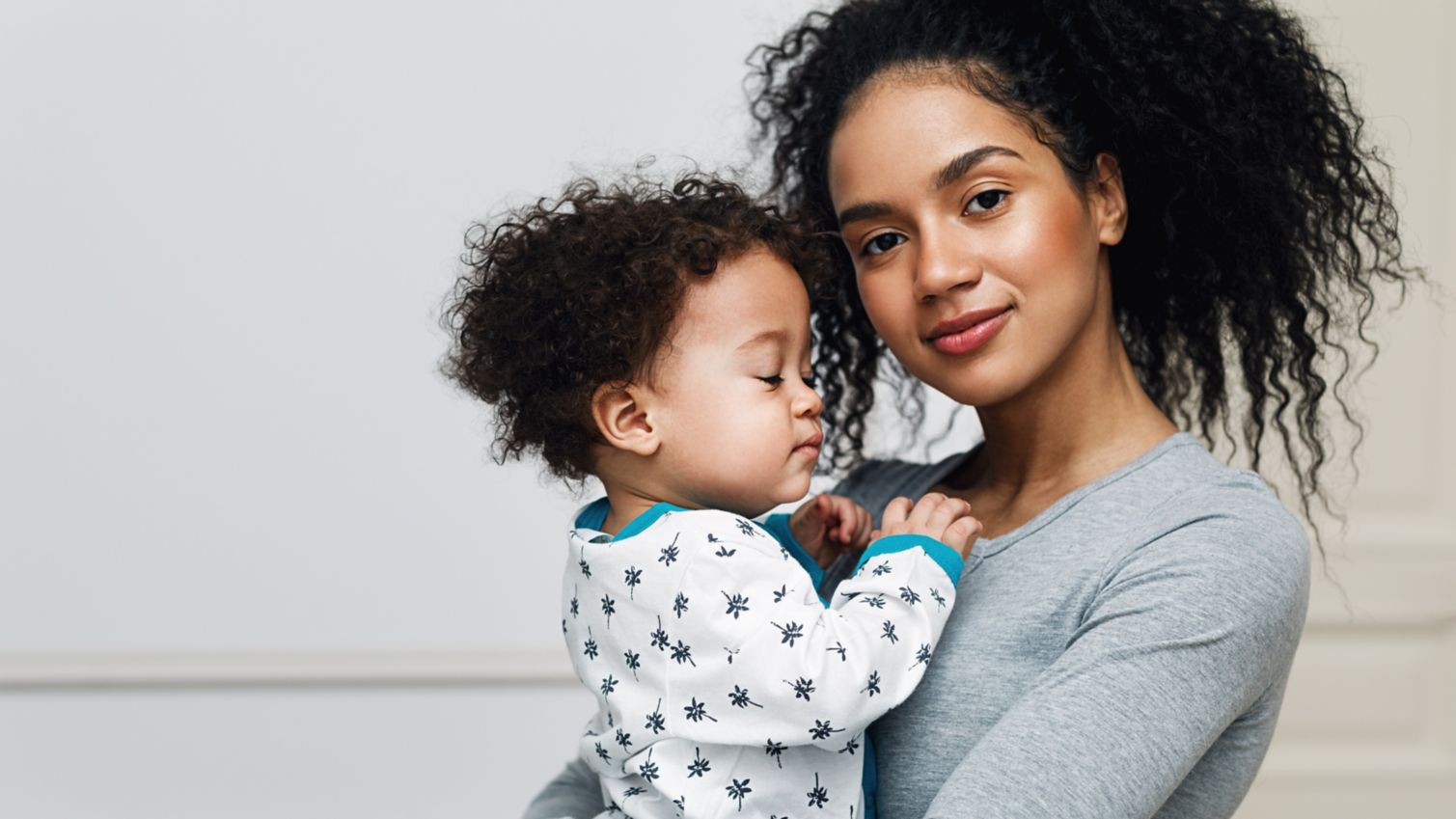 Mom holds small child