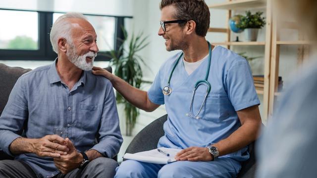 A man sits in his home and speaks with his provider. 