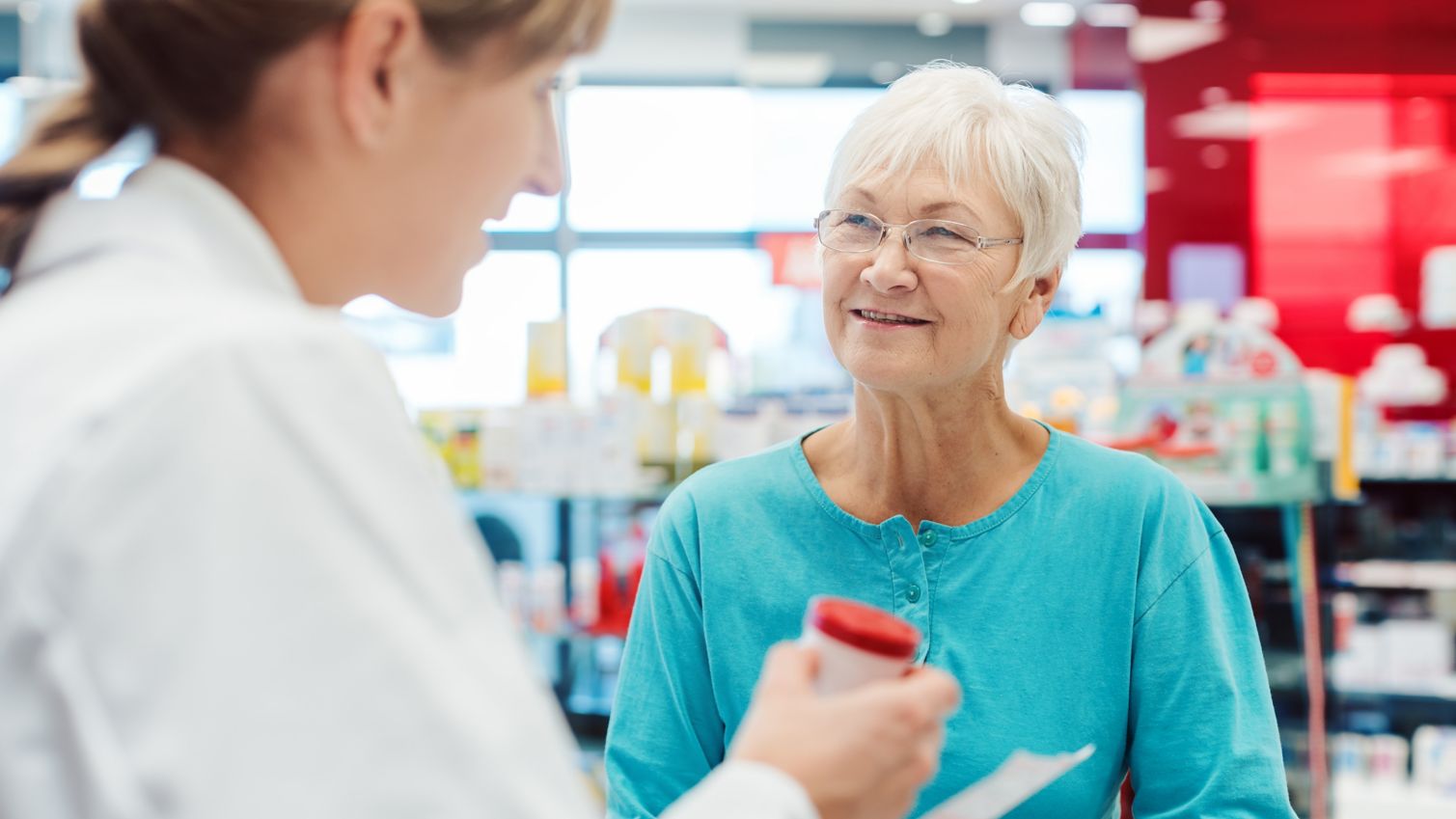 A retired woman talking to her pharmacist