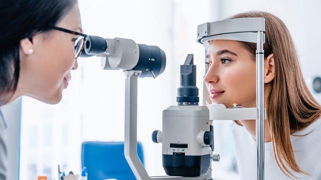 An eye doctor checks a woman's vision. 