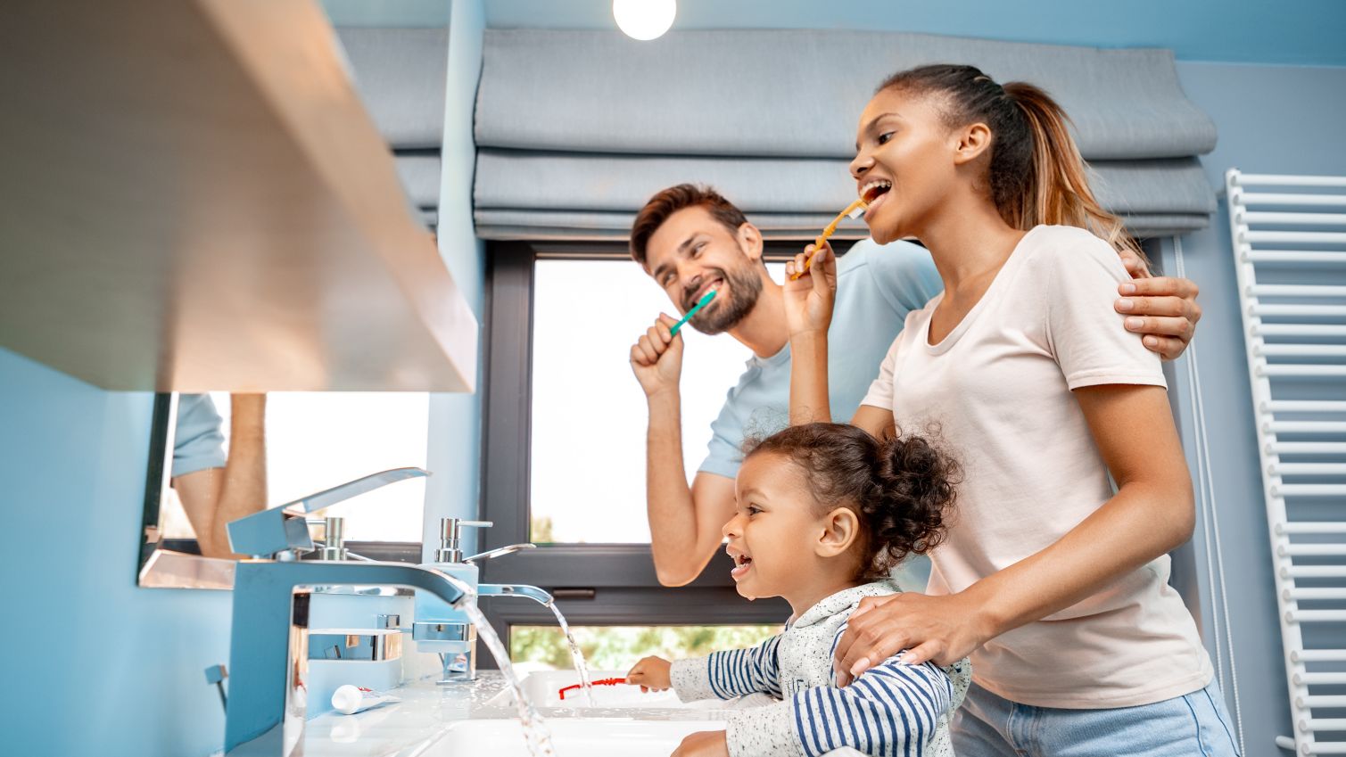 A family brushes their teeth together.