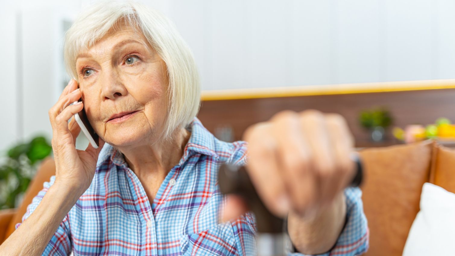 An elderly woman talking on her mobile phone