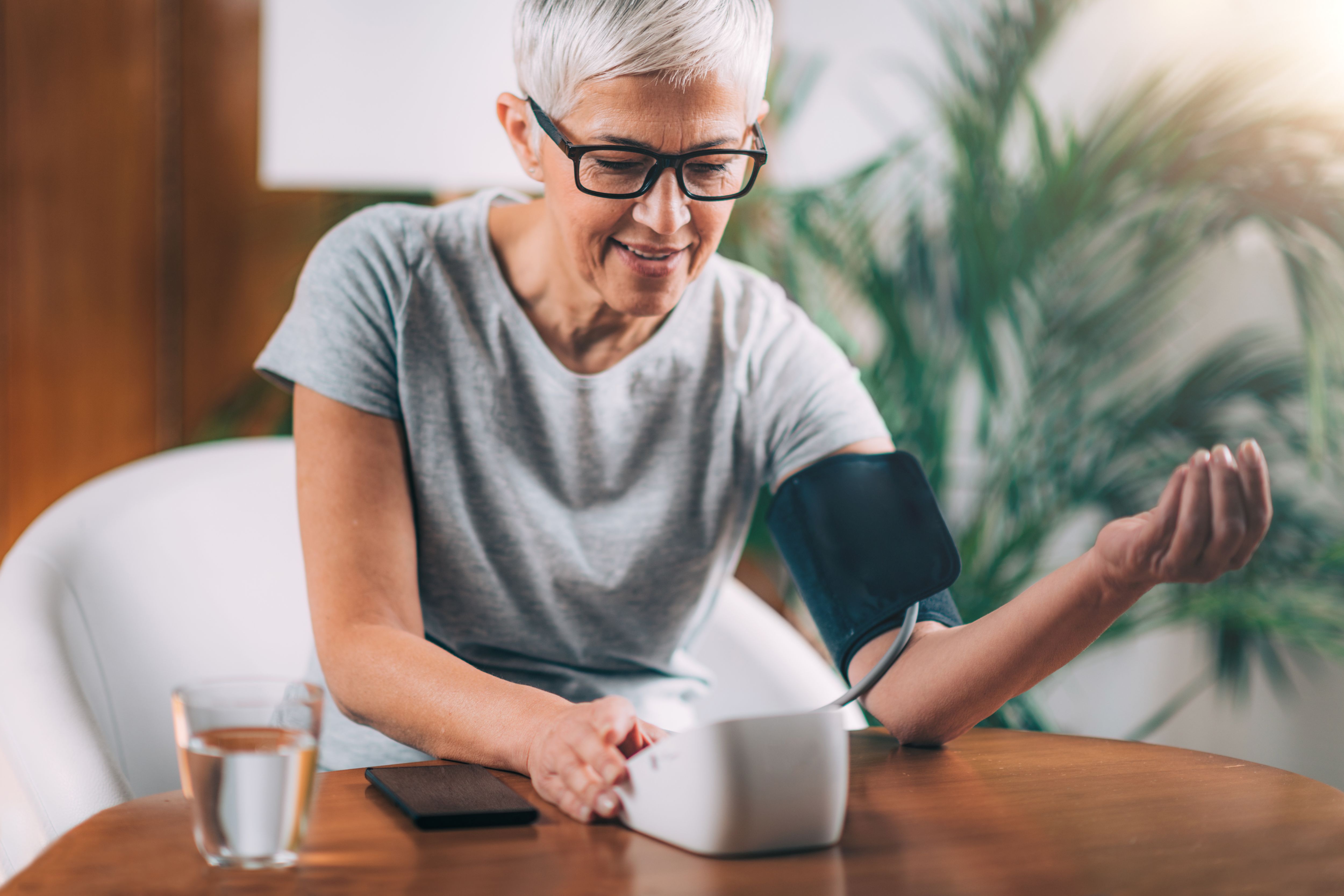 Woman using a blood pressure monitor. 