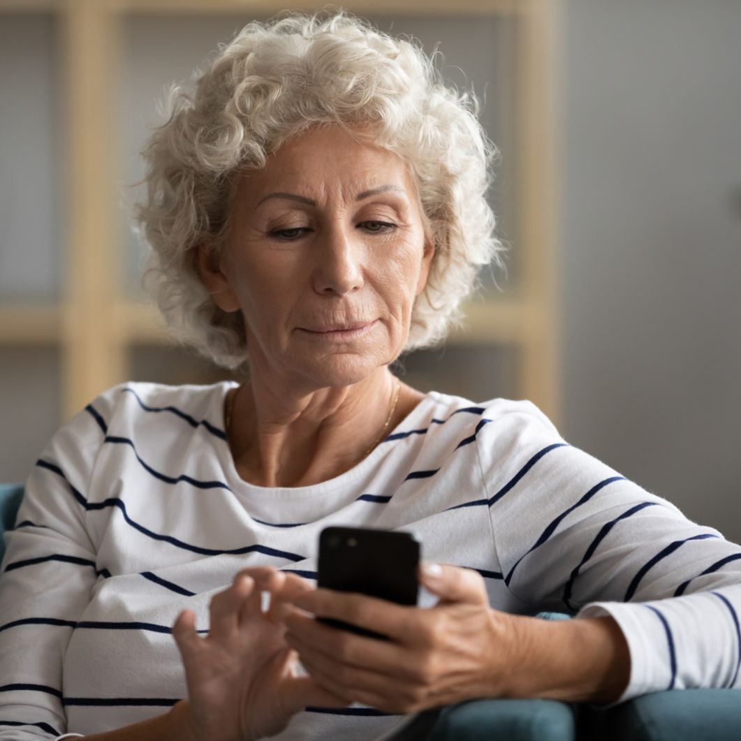 A woman uses a smartphone to make a phone call. 