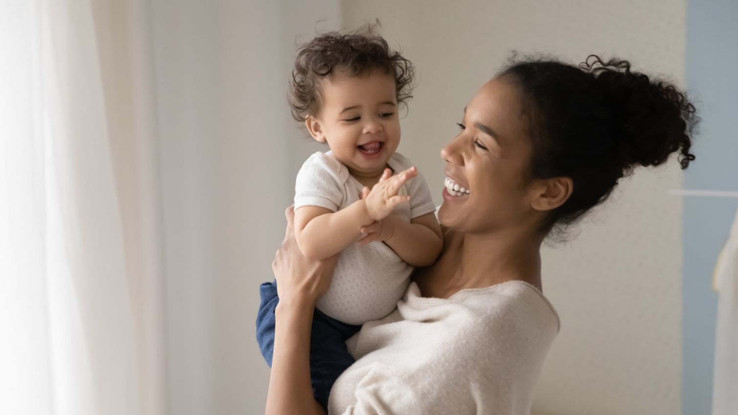 Mom holds her baby while playing