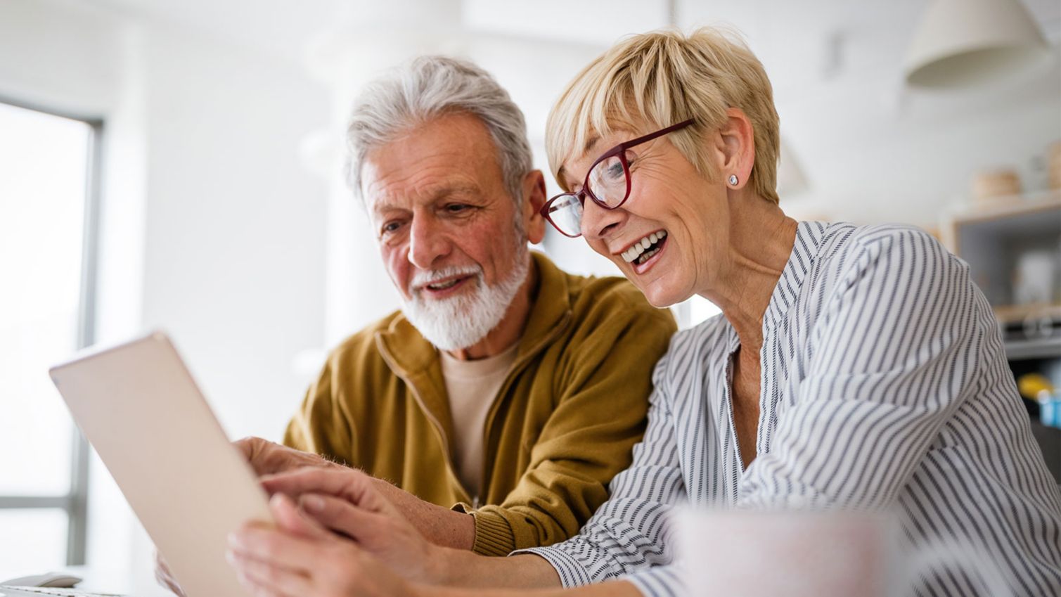 Cheerful couple at home taking a health survey on a smart pad