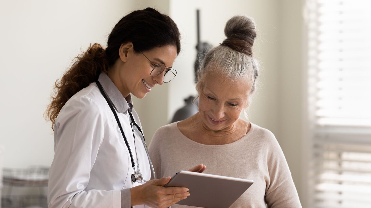 healthcare professional sharing results with patient on tablet