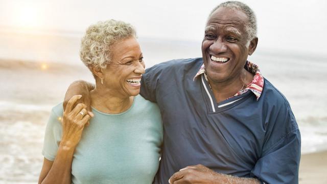 Man and woman walking on a beach.