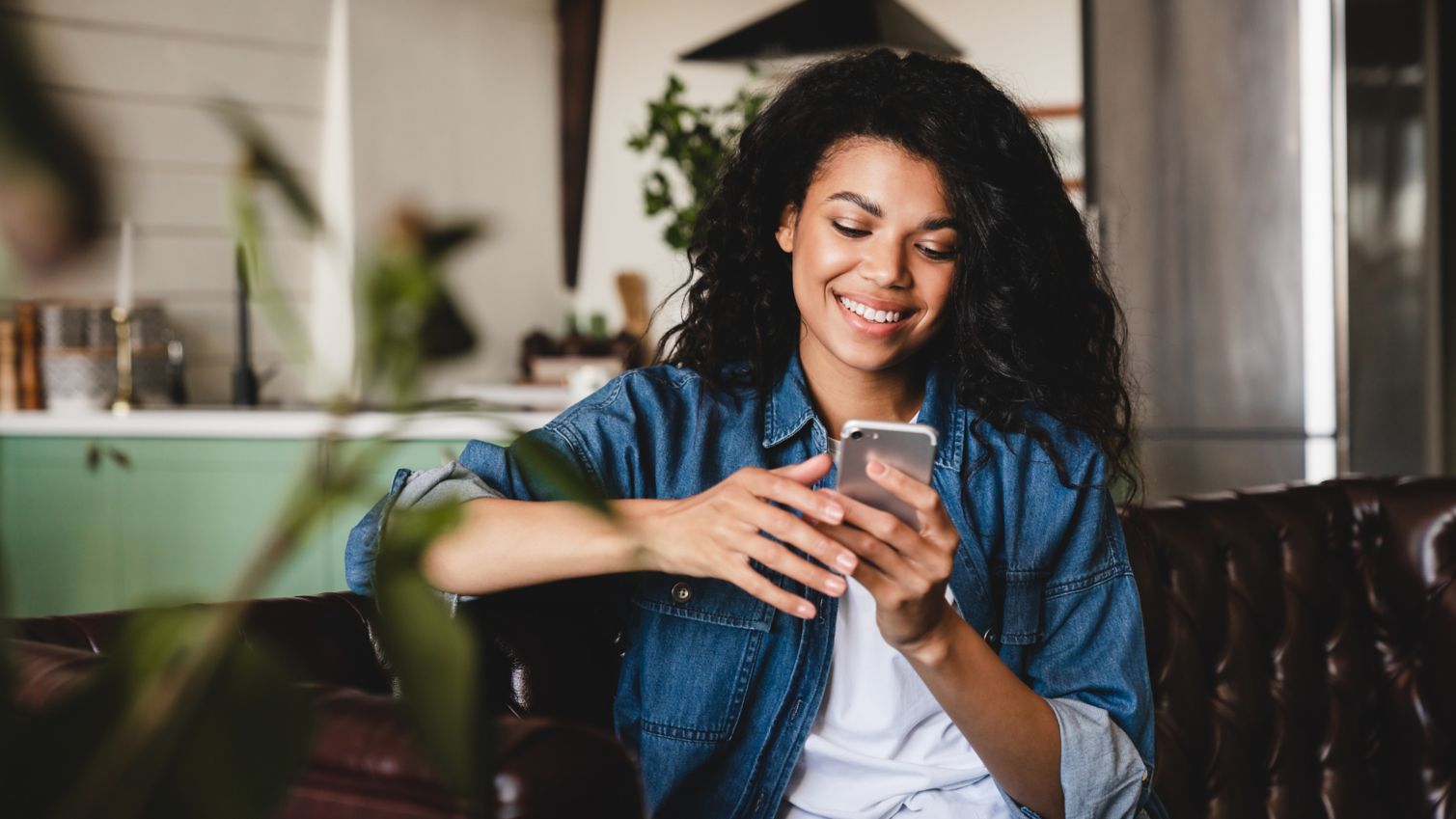 A young woman on her smartphone on her porch