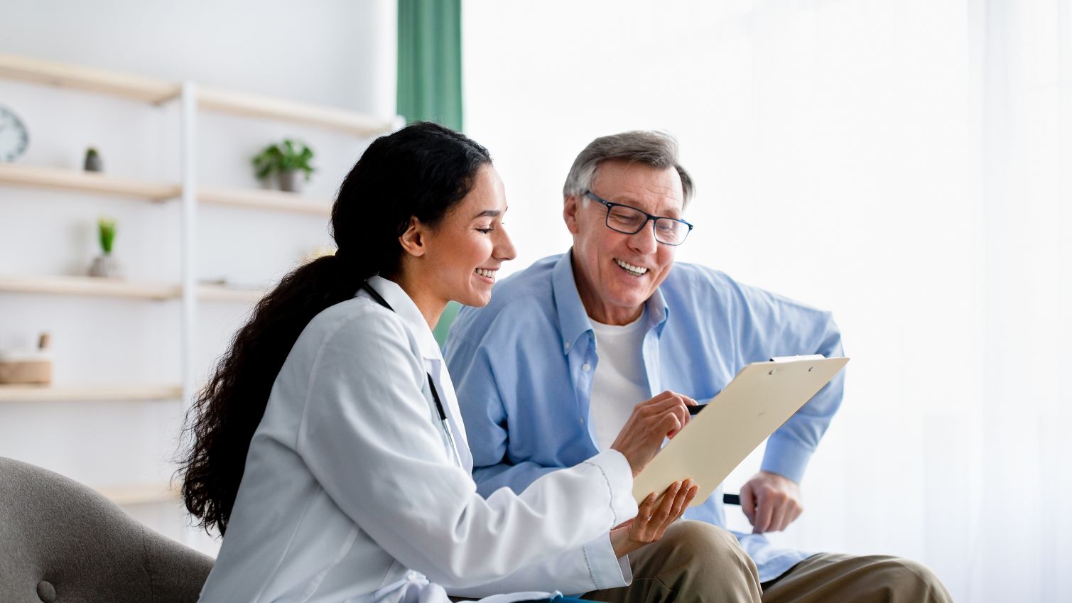 A provider goes over an older man's chart with him