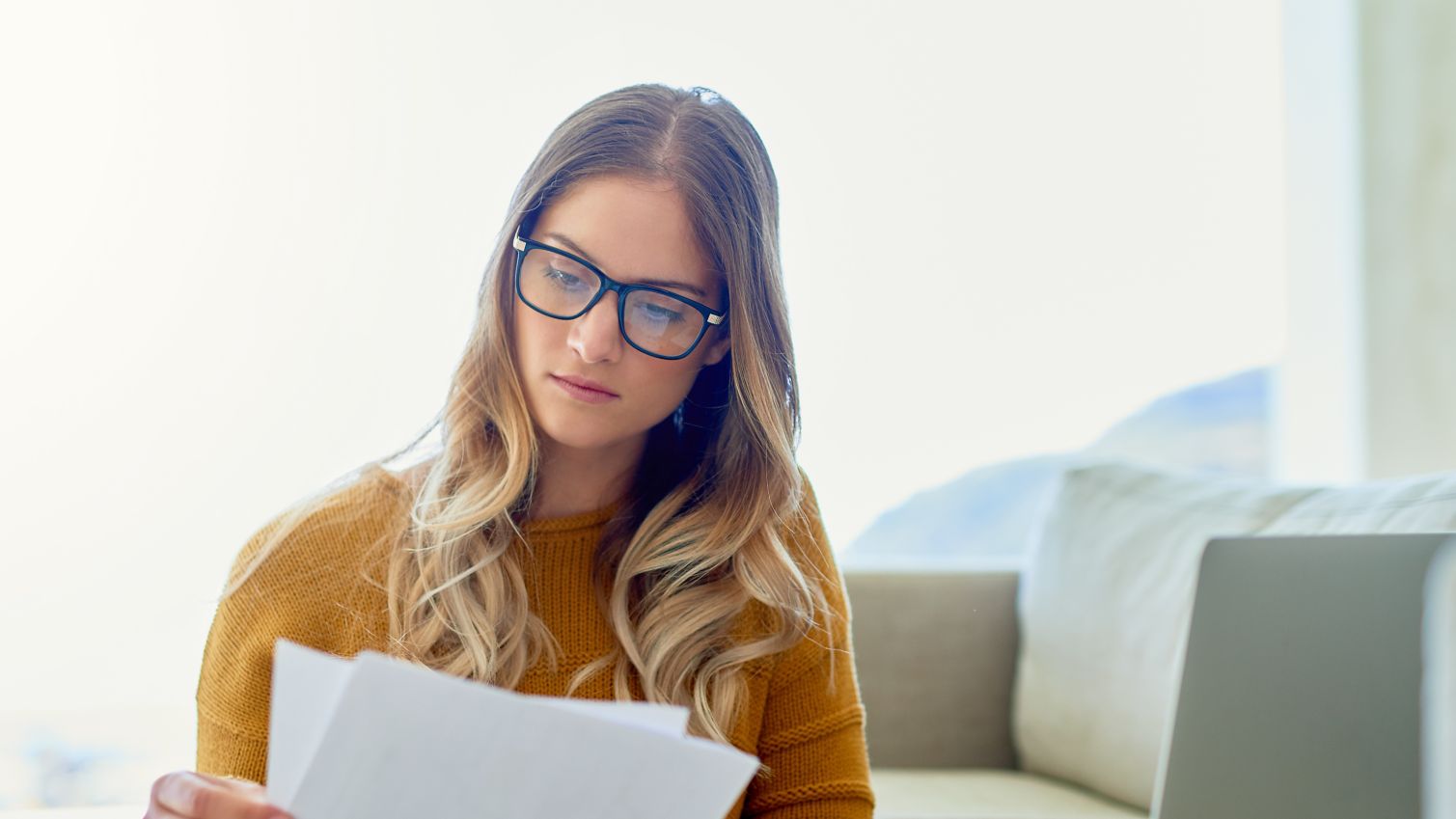 woman reading paperwork at home
