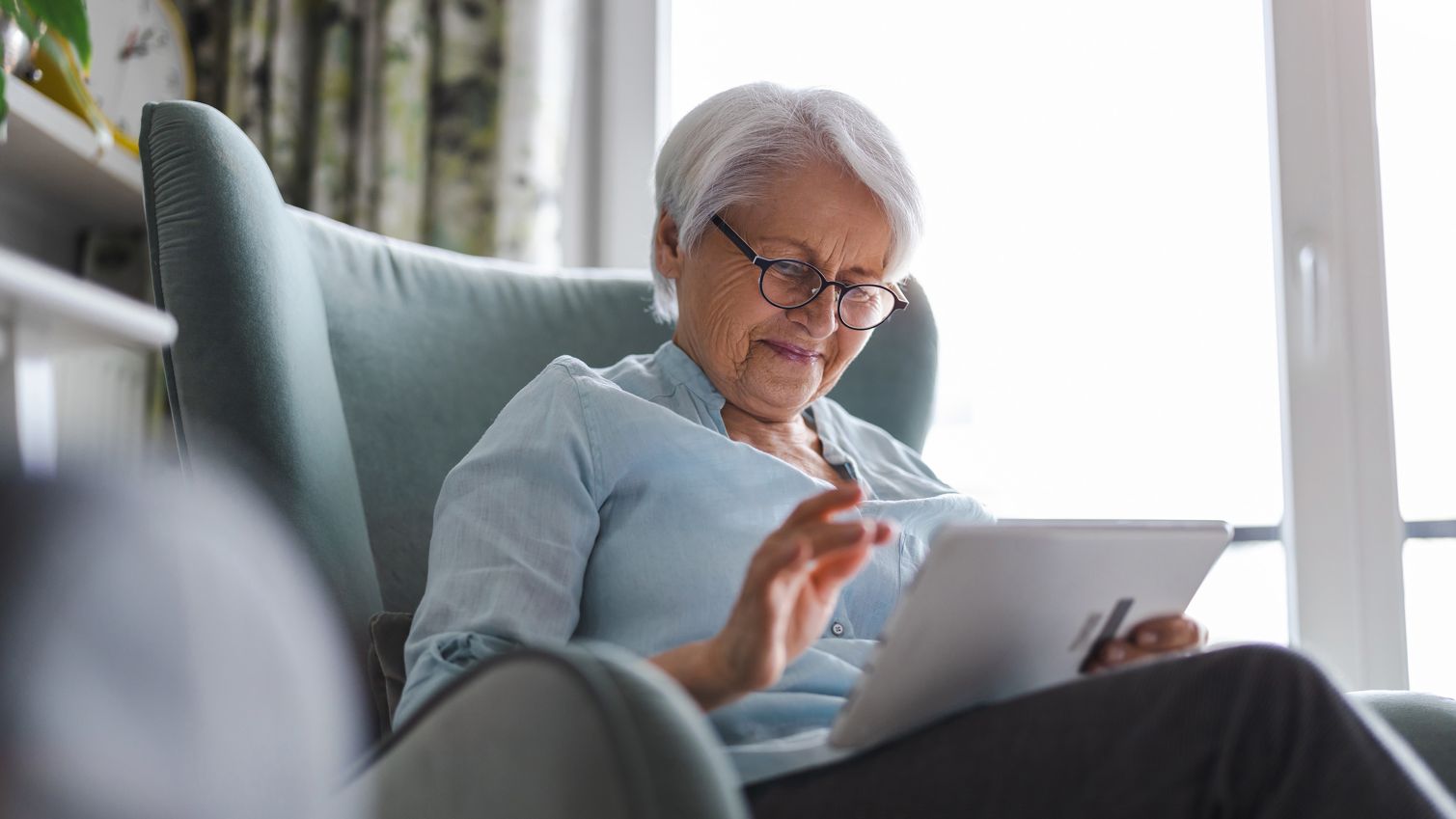 A woman has a videoconference appointment with a doctor using Humana’s telehealth service.