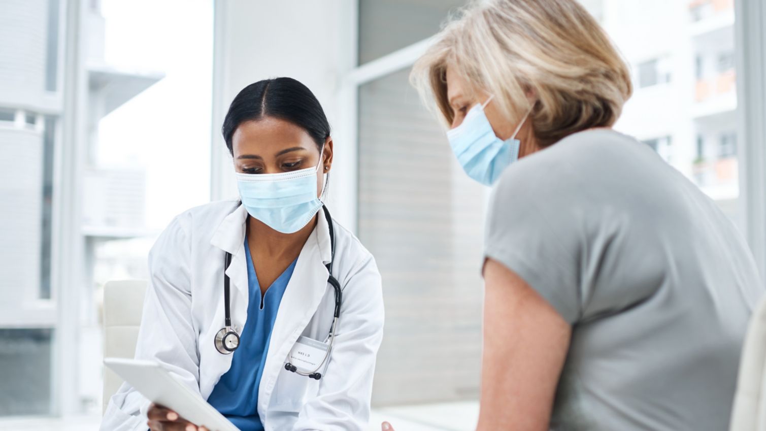 patient talking with doctor while looking at tablet