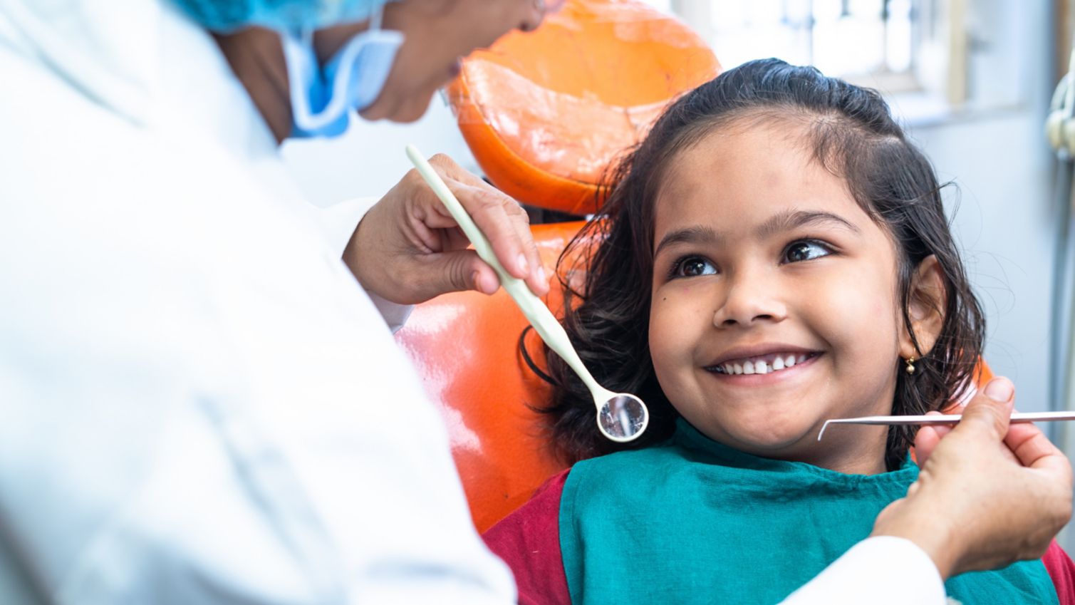 Child smiling at dental professional
