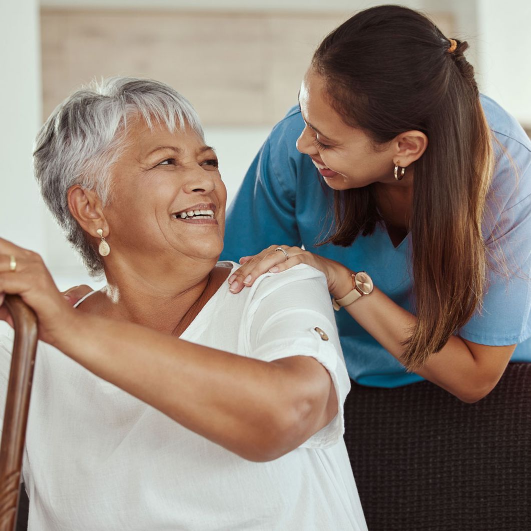 A nurse smiling at her patient.