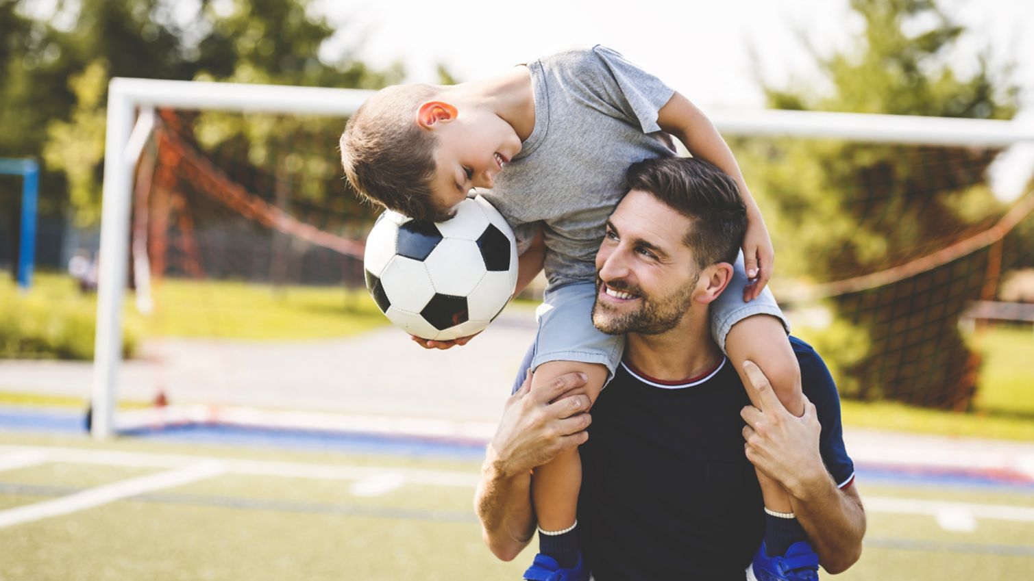 parent and child playing soccer