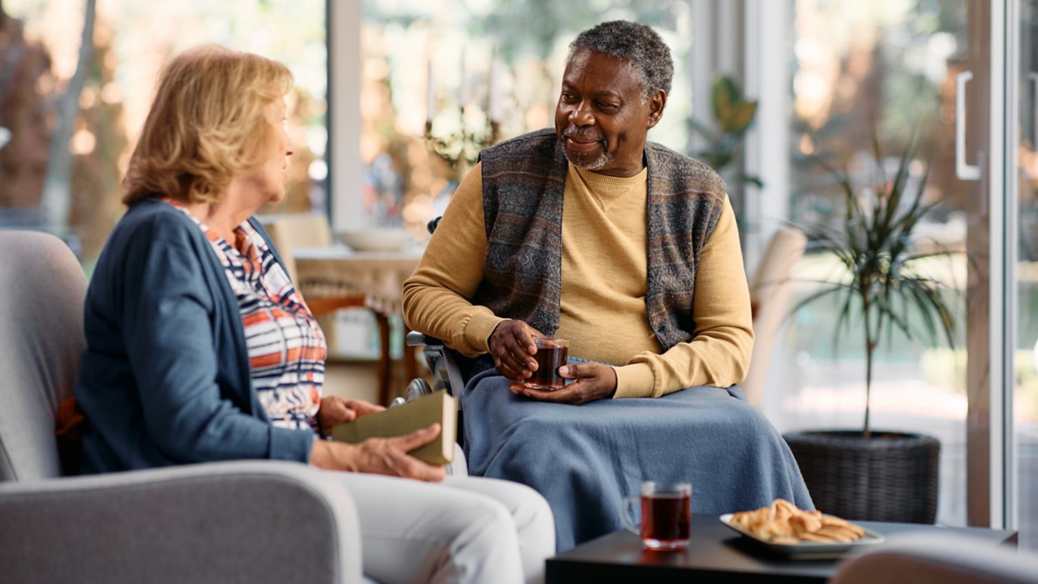 Two older adults sitting down