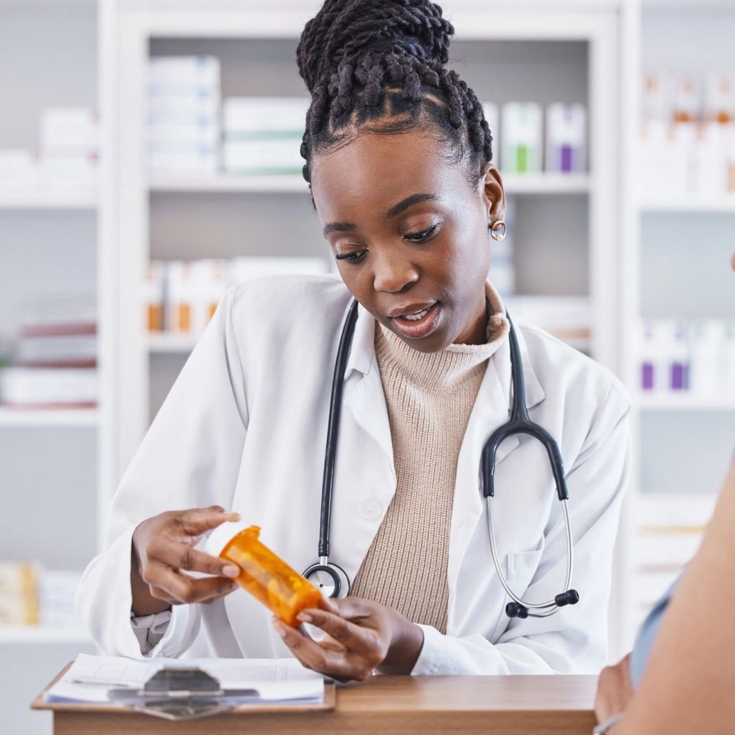 Pharmacy provider discusses medicine with patient
