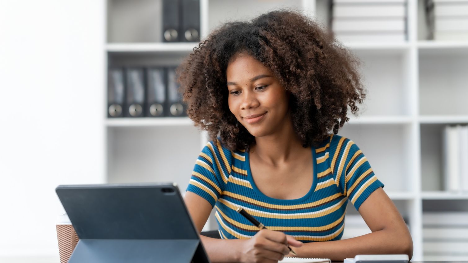 A woman looks up information on her laptop at home.