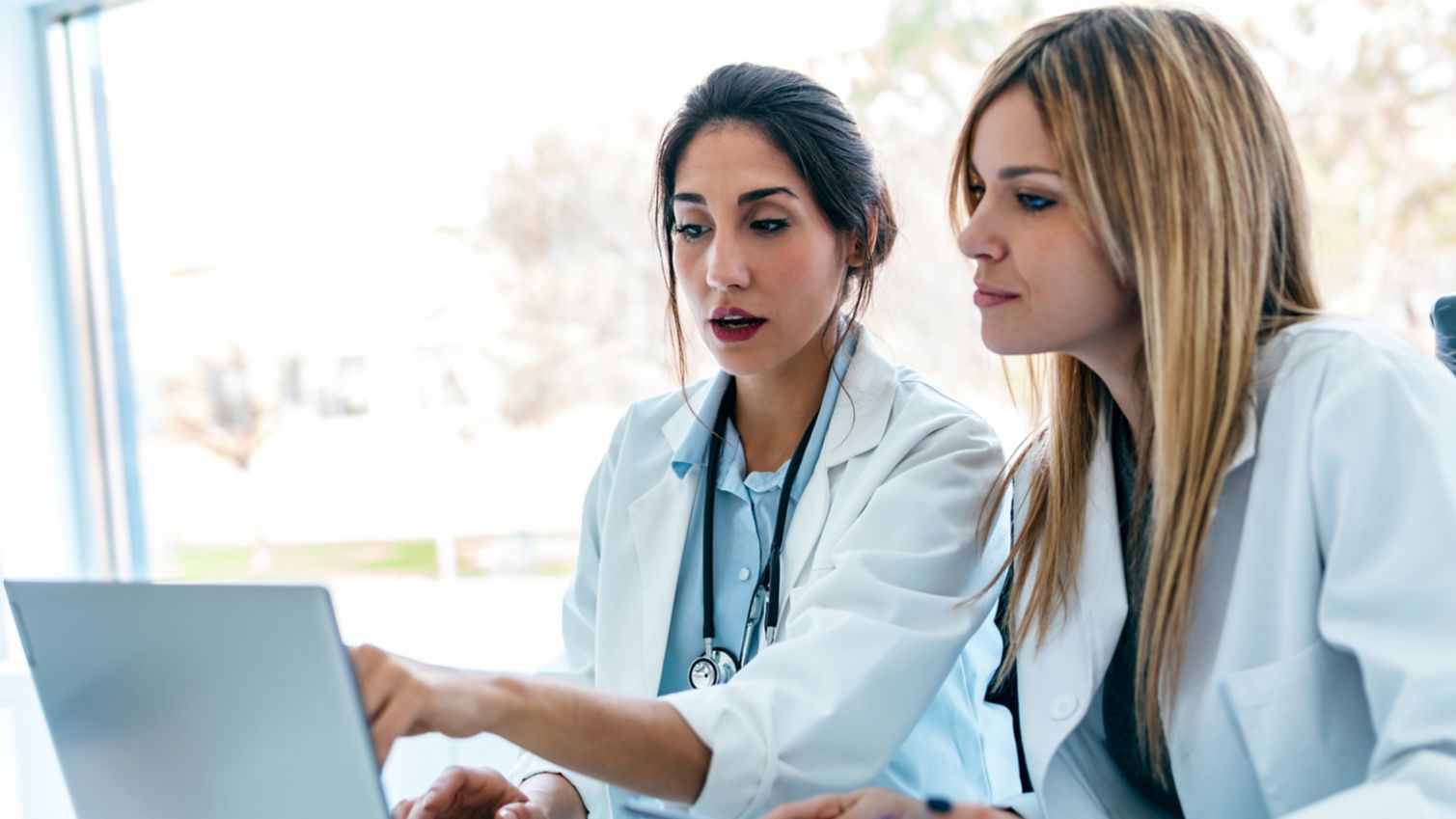 Two providers looking at computer together.